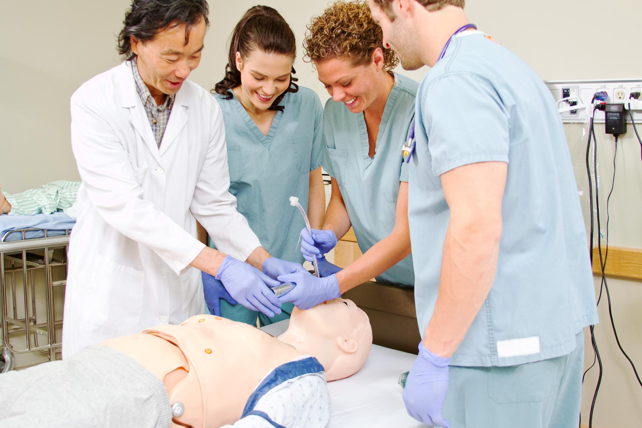 Nurses practicing on dummy